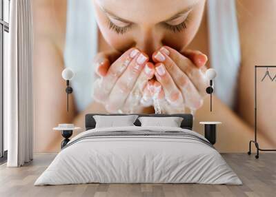 beautiful young woman washing her face splashing water in a home bathroom. Wall mural