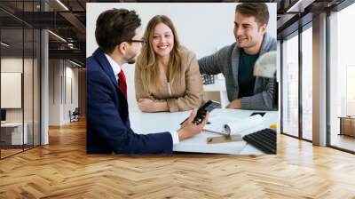 Business man explaining terms of contract to his clients in the office. Wall mural