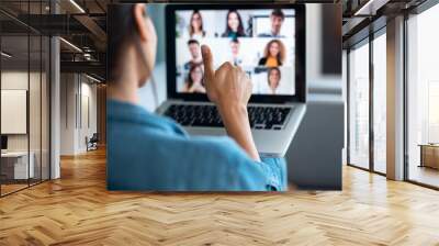 Business woman making video call and showing thumb up to laptop on the online briefing while sit on sofa at home. Wall mural