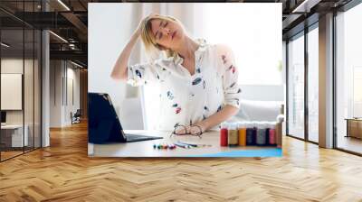 Business young woman stretching body for relaxing while working with digital tablet in the office. Wall mural