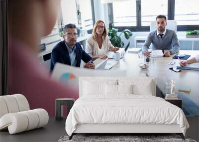 Businesspeople taking notes with laptop and paying attention in conference on coworking place. Wall mural