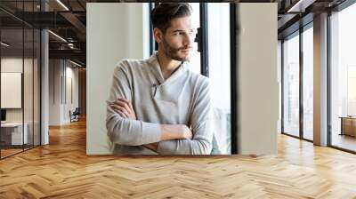 Handsome young man posing at home. Wall mural