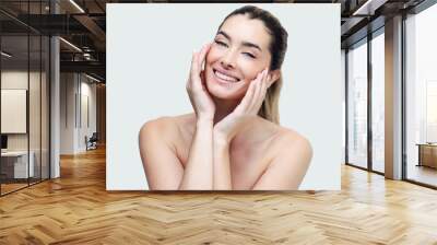 Portrait of a beautiful woman face with a healthy skin. Isolated on white. Wall mural