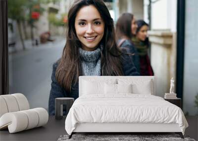 portrait of beautiful young woman looking at camera. Wall mural