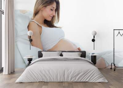 Pregnant woman relaxing at home. Wall mural