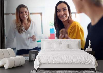 Three young entrepreneur women taking a break and having a breakfast in the office. Wall mural