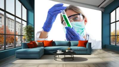 Young scientist woman with protective glasses looking test tube on white background. Wall mural