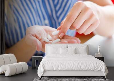 Young woman taking in pill. Wall mural