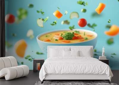 Bowl of soup and vegetables flying in the air on a blue background. Wall mural