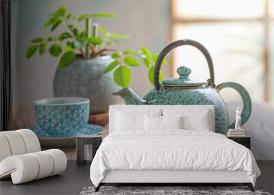 Green tea set on a wooden table with a white background, a close-up of a teapot and cup with a blue patterned surface. Wall mural