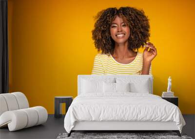 African afro woman with curly hair smiling. Wall mural