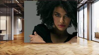 Beautiful afro woman posing in studio. Wall mural