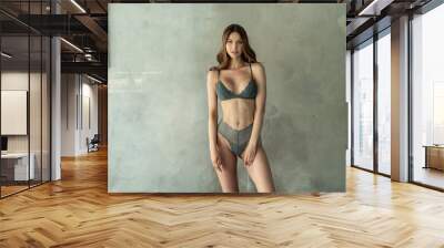 beautiful woman with ideal fit body wearing fashionable lingerie, standing and looking at the camera Wall mural