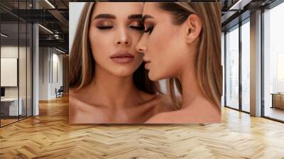 Beauty portrait of two beautiful young women with glowing glamour makeup and long straight hair. Aesthetic medicine concept. Wall mural