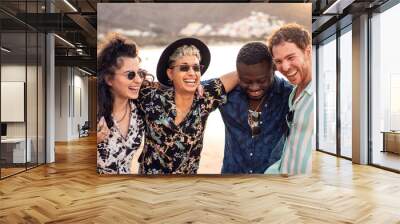 Group of happy multiracial friends having fun together on the beach, dancing and laughing. Mixed race people friendship concept. Multi ethnic students lifestyle Wall mural