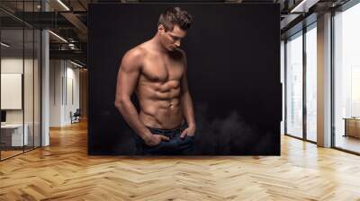 Handsome shirtless man in studio. Wall mural