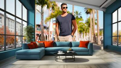 Handsome young man portrait. Men wearing fashionable sunglasses Wall mural