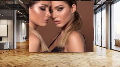 Portrait of two attractive women in glamour makeup. Wall mural