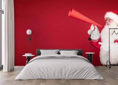 Santa Claus screaming through a huge megaphone. Wall mural