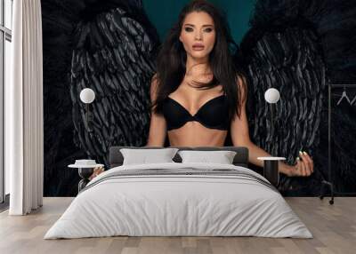 Sexy beautiful woman in lingerie and angel black wings. Wall mural