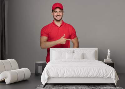 Smiling courier man posing in studio. Wall mural