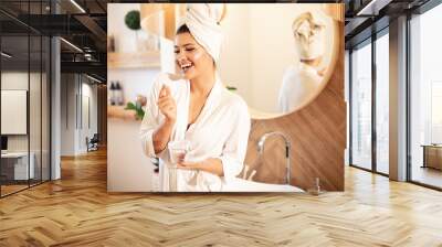 Young beautiful woman in bathroom. Wall mural