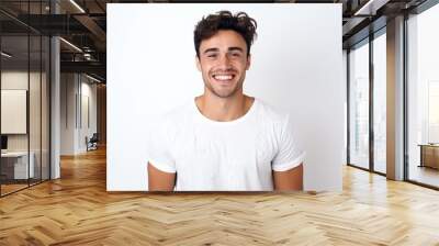 Portrait of a handsome young man smiling at camera over white background Wall mural