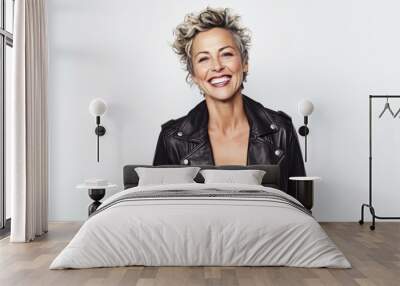 Portrait of a smiling woman in a leather jacket on a white background Wall mural