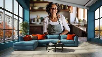 Portrait of a smiling young woman kneading dough in the kitchen Wall mural