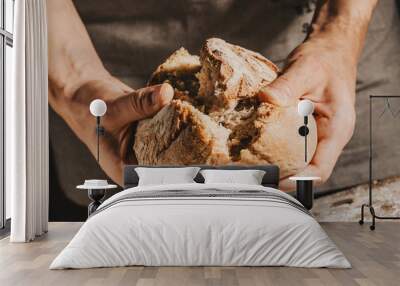 Baker or chef holding fresh made bread Wall mural