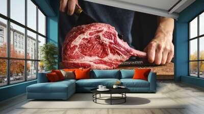 Butcher cuting fresh meat tomahawk steak Wall mural