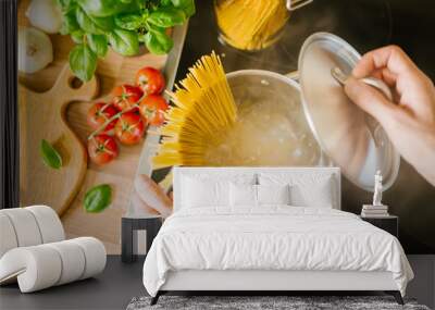 Man cooking pasta in boiling water Wall mural