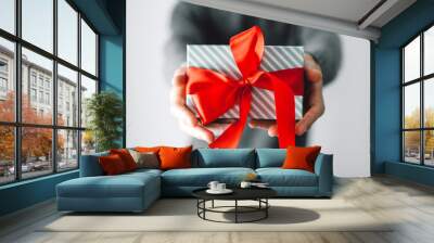 Man holding gift with red ribbon Wall mural