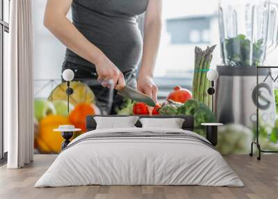 Pregnant woman cooking healthy food Wall mural