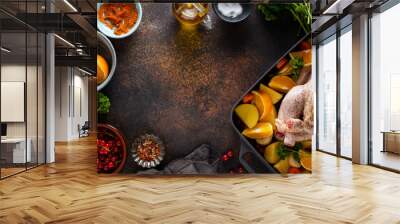 Raw chicken with ingredients being cooked Wall mural