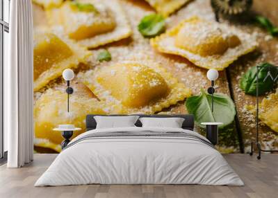 Raw ravioli with basil and flour on wooden Wall mural