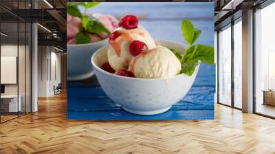 Tasty appetizing vanilla and strawberry ice cream with jam in bowls on wooden table. Closeup. Wall mural