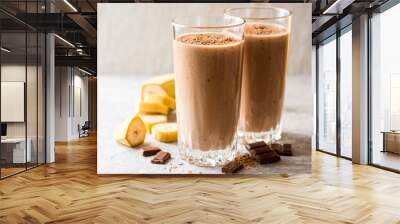 Chocolate banana smoothie in glass on gray stone background Wall mural