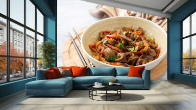 Fried chicken gizzards with carrot and onion in bowl on concrete background. Selective focus. Wall mural