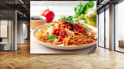 Spaghetti pasta with tomato sauce, mozzarella cheese and fresh basil in plate on white wooden background. Selective focus. Wall mural