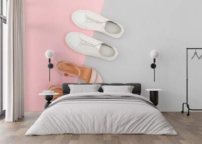 White sneakers and pink heeled sandals on grey and pink paper background. Stylish spring or summer woman's shoes in pastel colors. Trendy beauty female fashion background. Flat lay, top view. Wall mural