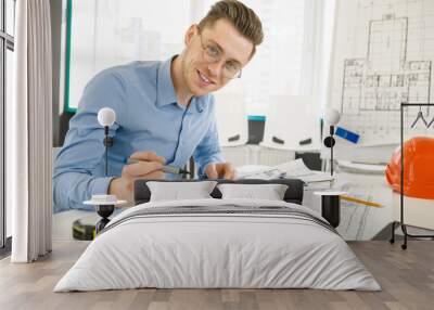 Young male architect working at his office Wall mural