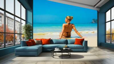 Cute woman relaxing on the summer beach. Wall mural