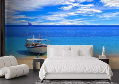 fishing boat on the shore in the ionian sea in greece Wall mural