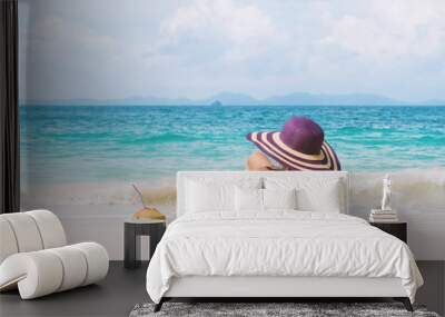 Happy young woman in straw hat with  on the beach Wall mural