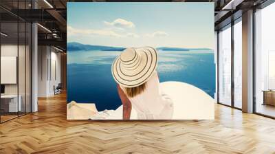 Luxury travel vacation woman looking at view on Santorini island Wall mural