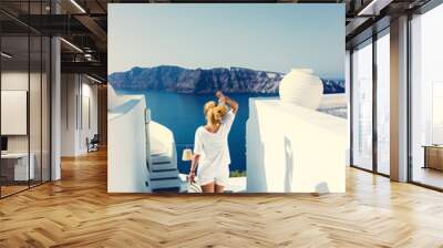 Luxury travel vacation woman looking at view on Santorini island Wall mural