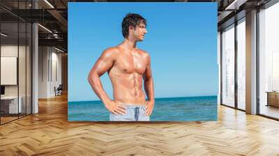 Portrait of a handsome young muscular man in swimwear Wall mural