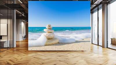 Stones pyramid on sand symbolizing zen, harmony, balance. Ocean Wall mural