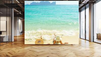 Two 2 young beautiful girls sunbathing on the tropical beach Wall mural